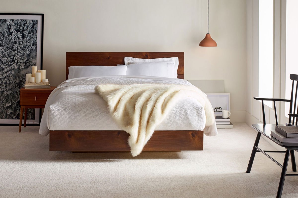 Serene white bedroom featuring plush carpet flooring from Carpet & Flooring Warehouse